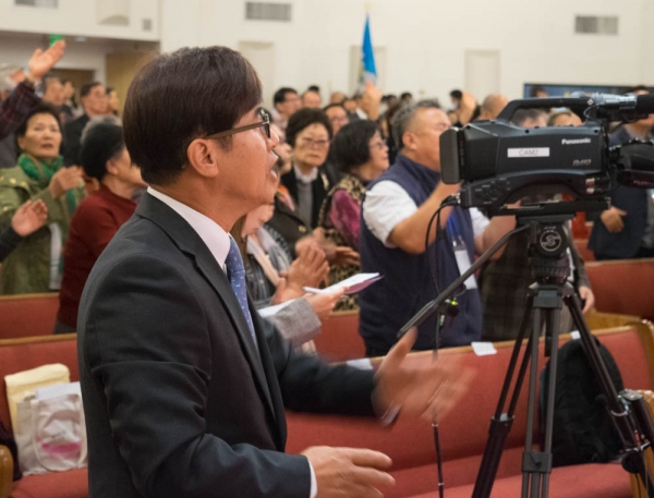 Rev. Sam Shin worships with around 400 people at a world education missions conference held at Young Nak Presbyterian Church on February 1, 2018