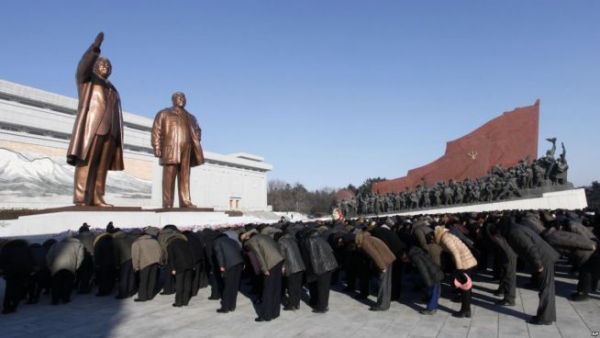 People bow down to Kim Il Sung and Kim Jong Il statue. It was built on the site of Jang Dae-hyun's church, a symbol of revival in Pyongyang