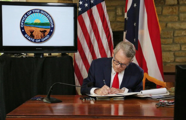 Mike DeWine signed legislation Wednesday curbing his power to change Ohio elections and close houses of worship in the state. 