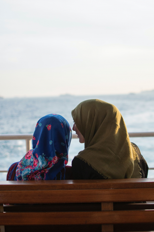 (Picture: Two muslim females sitting on a bench.) Two muslim females sitting on a bench.