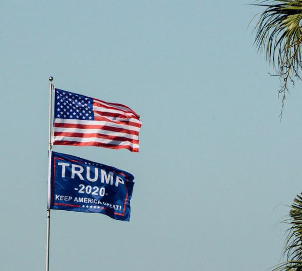 US Flag on a pole alongside President Trump's banner