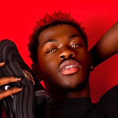 Lil Nas X holding the demonic pair of 