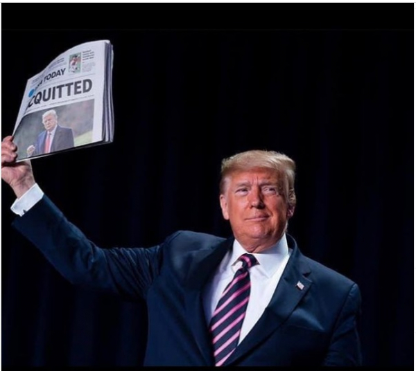 Former President Donald J. Trump holding newspaper saying he's acquitted
