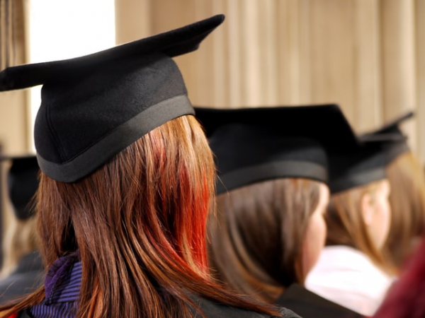 women wearing graduation hats and dresses