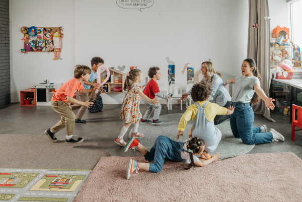 Women Kneeling on the Floor with Children in a Room