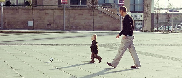 A Father and Son Play Soccer