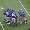 The New York Giants Huddle on Field