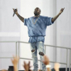 Kanye West performs at a ceremony and thanks the Lord. 