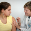 Teen receiving injection from doctor