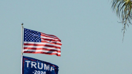 US Flag on a pole alongside President Trump&#039;s banner