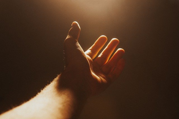 hand lifted up in prayer and worship