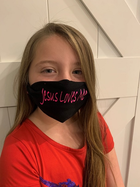 Lydia Booth and her "Jesus Loves Me" face mask.