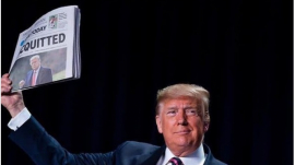 Former President Donald J. Trump holding newspaper saying he&#039;s acquitted