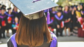 woman wearing academic cap and dress graduation student