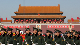 Members of China&#039;s People&#039;s Liberation Army (PLA) walk past the Tiananmen Gate in Beijing, China.