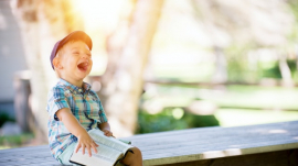 Child reading a Bible laughing happy life