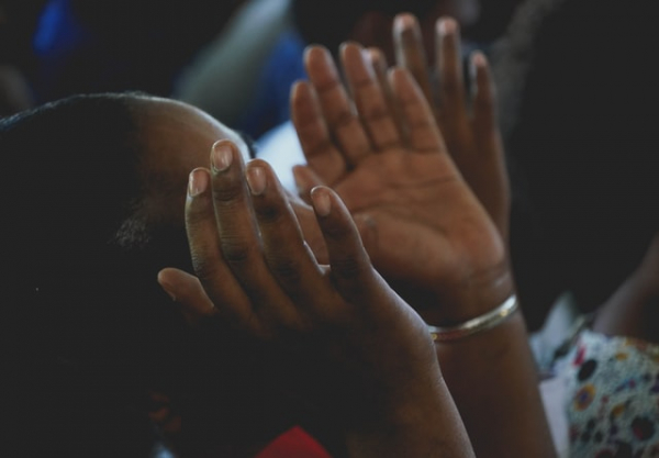 hands raised in prayer and worship in church