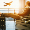 man sits on gang chair inside the airport, left by his flight