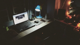 laptop computer in table being used in a dark room at night