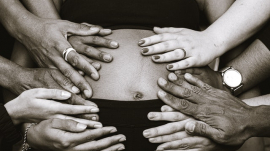 pregnant mom with many hands holding her tummy