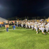 Upperman High School and Stone Memorial High School football players leading the community in a post-game prayer