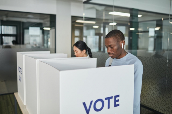 voters voting in person inside voting center