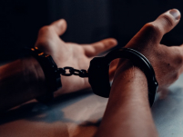 person&#039;s hands in cuffs