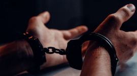 person&#039;s hands in cuffs