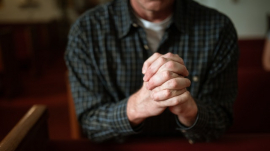 man praying inside church building