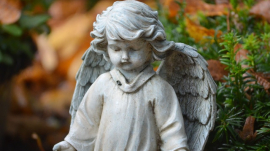 statue of a little child with wings like an angel