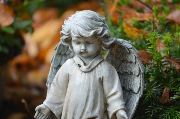 statue of a little child with wings like an angel