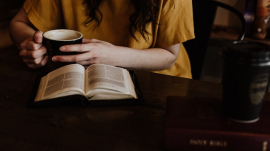 woman having quiet time with her Bible and a cup of drink