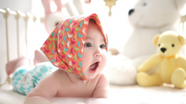 baby wearing a scarf over the head
