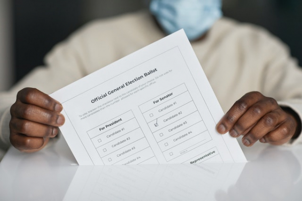 man holding voter's ballot form