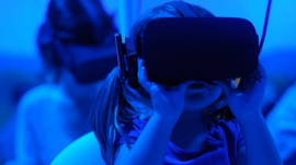 little girl using VR goggles