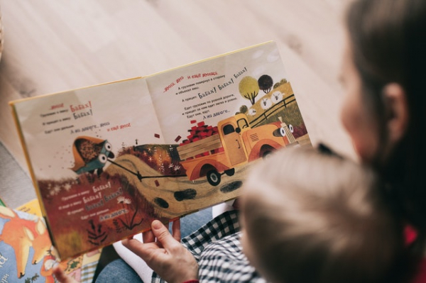 mother reading a book to her child