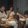 Family praying before eating dinner during Christmas