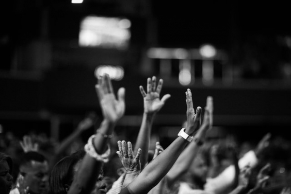 hands raised in worship in church