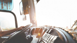 Truck driver holding steering wheel dashboard