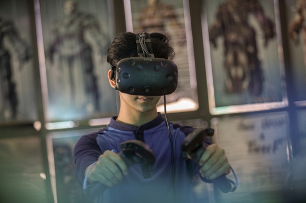 kid playing games using Facebook's Oculus VR headset
